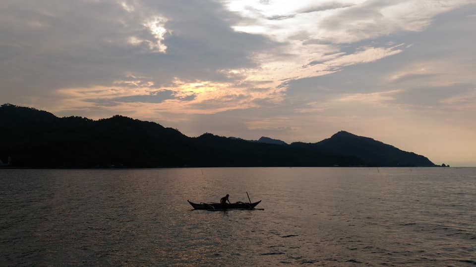 A fisherman casting his nets near the old pier.